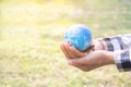 Hand farmer holding earth on dry ground blured. Royalty Free Stock Photo