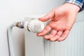 Hand on the faucet or temperature regulator on the radiator of the heating system, selective focus. Background Royalty Free Stock Photo