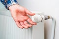 Hand on the faucet or temperature regulator on the radiator of the heating system, selective focus. Background Royalty Free Stock Photo