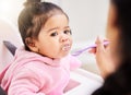 Hand, feed and child food in chair for baby development, nutrition meal or dinner snack. Kid, spoon and eating breakfast Royalty Free Stock Photo