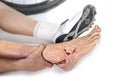 Hand and feet of young man holding wounded ankle after bike riding crash accident injury bleeding