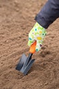 Hand Female In Work Glove With Garden Scoop In Soil Ground In Garden Outdoor In Spring Close Up Royalty Free Stock Photo