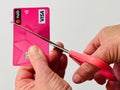 Hand of a female cutting a credit card with scissors