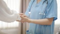 Hand of female doctor comforting patient at consulting room Royalty Free Stock Photo