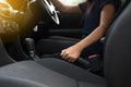 Hand female driver pulling the hand brake inside car Royalty Free Stock Photo