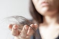 Hand of female holding hair fall or loss  is a problem of women on white background Royalty Free Stock Photo