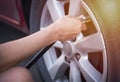 Hand of female inflate a tire before traveling. Royalty Free Stock Photo