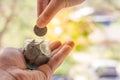 Hand of female putting coins in jar Royalty Free Stock Photo