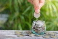 Hand of female putting coins in jar Royalty Free Stock Photo