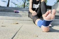 Hand female using elastic bandage with legs,Female putting bandage on her injured foot from sport Royalty Free Stock Photo