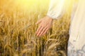 Hand of a female in white ethnic shirt touching