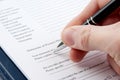 Hand filling in empty medical questionnaire Royalty Free Stock Photo