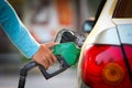 Hand Filling fuel car at gas station