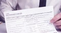 Hand filling health insurance claim form. Closeup shot Royalty Free Stock Photo