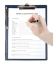 Hand filling in medical questionnaire form in a clipboard Royalty Free Stock Photo