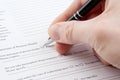 Hand filling in medical questionnaire form Royalty Free Stock Photo