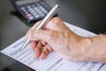 Hand filling retirement claim application Royalty Free Stock Photo