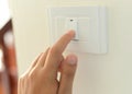 Hand with finger on light switch,