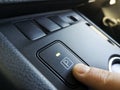 Hand finger pressing park gear button on automatic transmission car interior close up Royalty Free Stock Photo