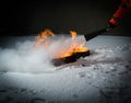 Hand of a firefighter putting out the fire on the snow Royalty Free Stock Photo