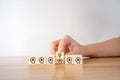 Hand flip over wooden cube block with head human symbol and light bulb icon. Brainstorming ideas concept Royalty Free Stock Photo