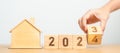 hand flip 2023 to 2024 block with house model. real estate, Home loan, tax, investment, financial, savings and New Year Resolution Royalty Free Stock Photo