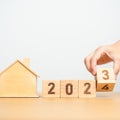 hand flip 2023 to 2024 block with house model. real estate, Home loan, tax, investment, financial, savings and New Year Resolution Royalty Free Stock Photo