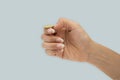 Hand is flipping a coin isolated on blue background Royalty Free Stock Photo