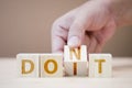 Hand flipping wooden cubes for change wording between don`t to do it.Mindset for career growth business Royalty Free Stock Photo