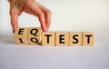 Hand flips cubes and changes the expression `IQ test` to `EQ test`. Beautiful white background. Psychological concept. Copy sp Royalty Free Stock Photo