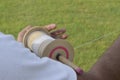 Hand flying kite holding thread on a grassland