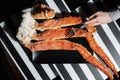 Hand with fork on background of king crabs legs, top view, gourmet seafood