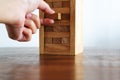 Hand fulfill a missing important piece jenga puzzle, business success concept