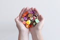 A hand full of minerals and gemstones