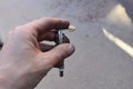 Hand Gapping a Spark Plug with Tool in the Driveway