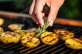 hand garnishing grilled potatoes with fresh rosemary