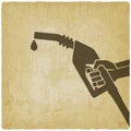 Hand with gasoline fuel nozzle on vintage background Royalty Free Stock Photo