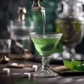 A hand gently dropping a sugar cube into a glass of absinthe with an ornate spoon1