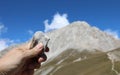 hand of the geologist holding a stone and the mountain called Gr
