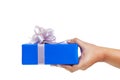 Hand gesture giving a gift wrapped in blue Royalty Free Stock Photo