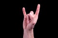 Hand of euroopean human shows the sign of the horns on  black background Royalty Free Stock Photo