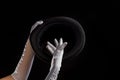 Hand gestures. Showman shows disappearing tricks in a hat, white gloves and black top hat,