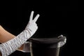 Hand gestures. Showman shows disappearing tricks in a hat, white gloves and black top hat,