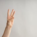 Hand gestures. woman& x27;s hand, three fingers up. Countdown, number three on your fingers. Royalty Free Stock Photo