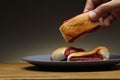 Hand getting a freshly baked Filipino sweet bread