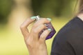 The hand of a girl with a bottle of perfume