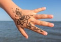 Hand girl with henna patterns on a blue background Royalty Free Stock Photo