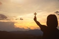 Hand of a girl holding a cross at sunrise, Eucharist Therapy Bless God Helping Repent Catholic Easter Lent Mind Pray. Prayer to Royalty Free Stock Photo