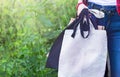 Hand of girl holding eco cloth canvas fabric bags and paper bag for organic shopping. Nature green background. Zero waste. Royalty Free Stock Photo