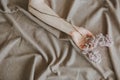 Hand girl lilac branch bed crumpled sheet Royalty Free Stock Photo